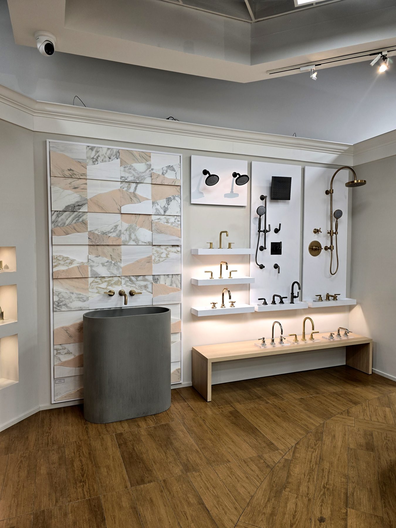 Marble panels behind a stone pedestal basin