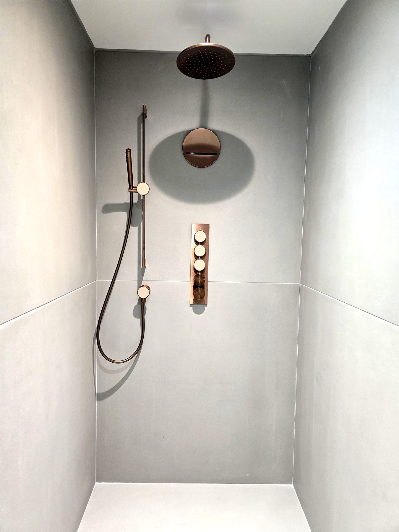 Walk-in shower with copper rain head